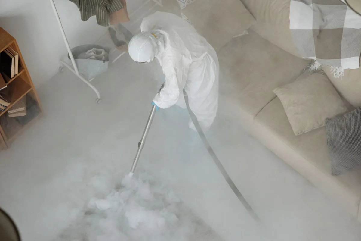 Biohazard cleanup technician in protective equipment, Eunice, NM